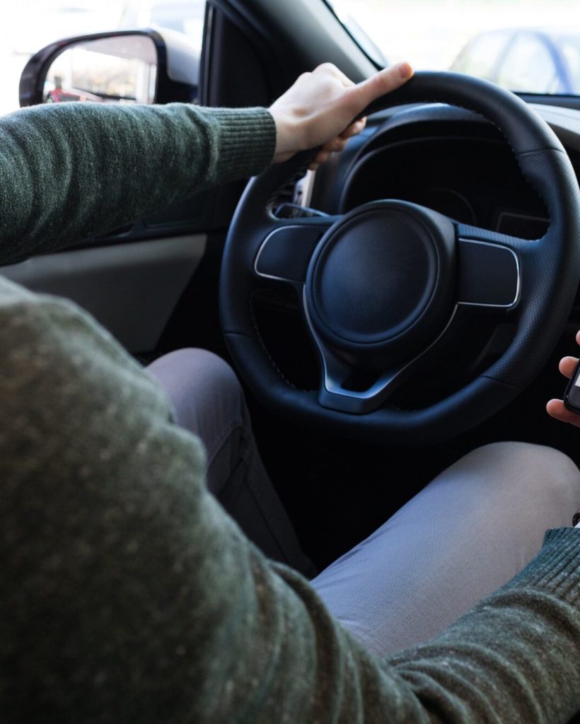 man-using-smartphone-while-driving-car.jpg